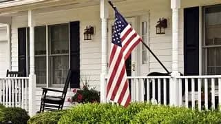 American flag flying on a house porch